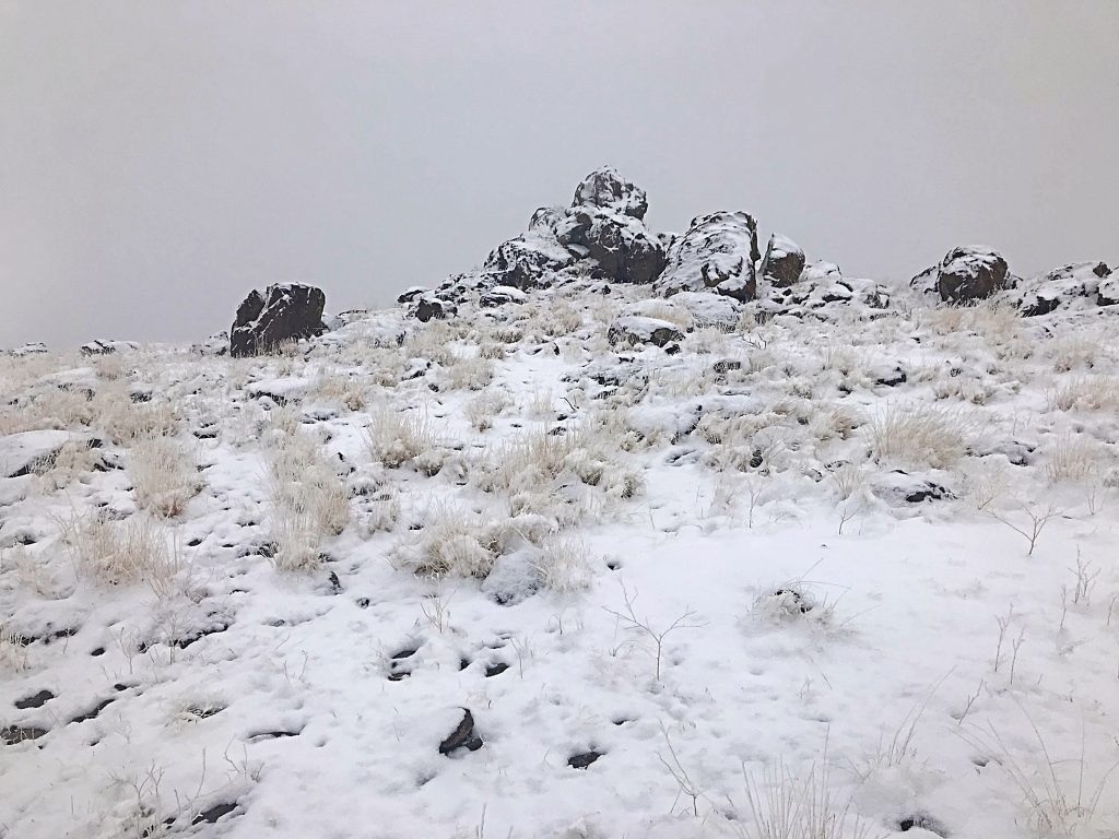 This outcrop is the highest point of Reynolds Peak. Circle around the north side where you will find a tall step that leads to the top. There is a summit register.