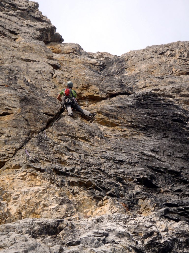 Cory on Pitch 1, just about to leave the right angling crack for the vertical seam. Photo - Kevin Hansen